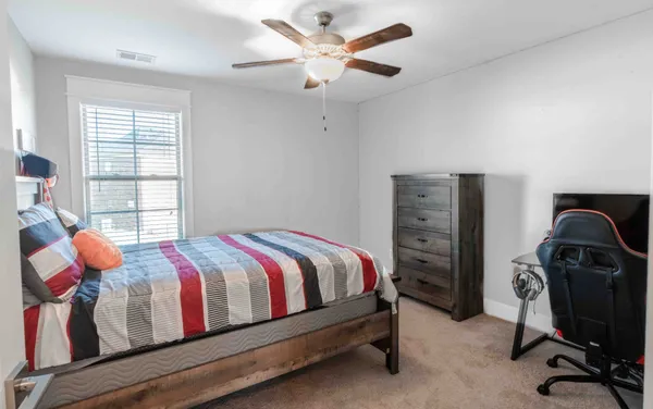 a bedroom with a bed and a chandelier