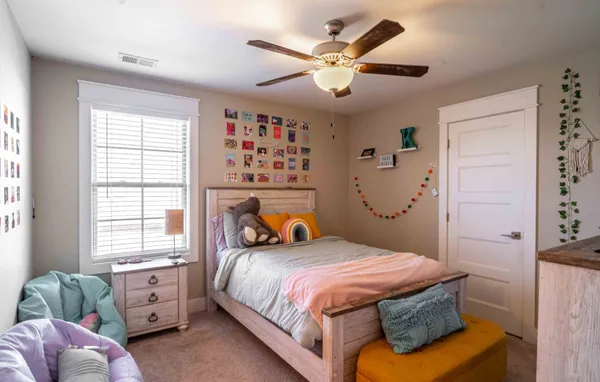 a bedroom with a bed and a window