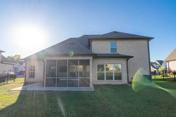 a view of a house with a yard and a large window