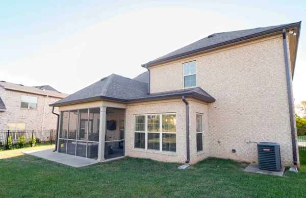 a view of a house with a yard and sitting area