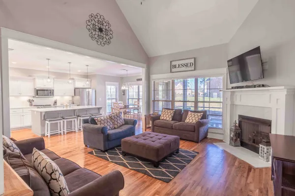 a living room with furniture fireplace and flat screen tv