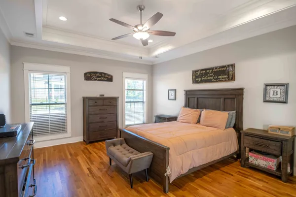 a bedroom with a bed dresser and a window