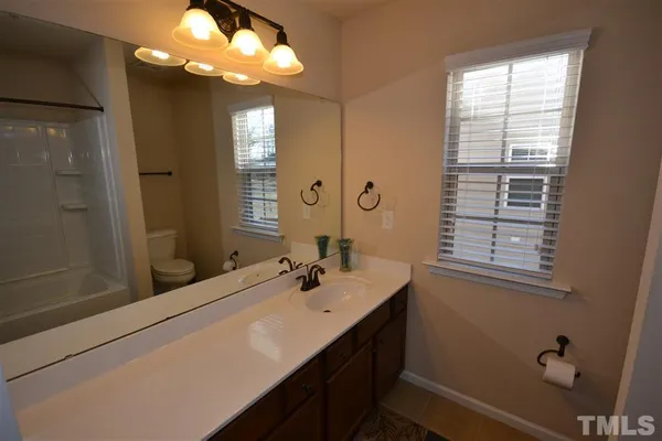a bathroom with a sink a large mirror and a shower