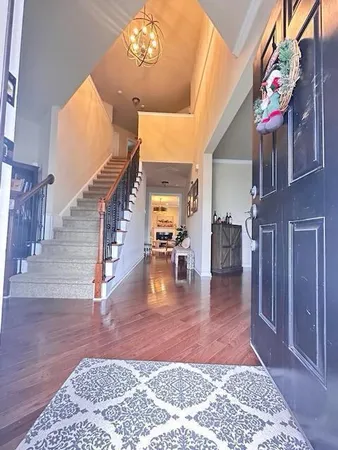 a view of entryway and hall with wooden floor
