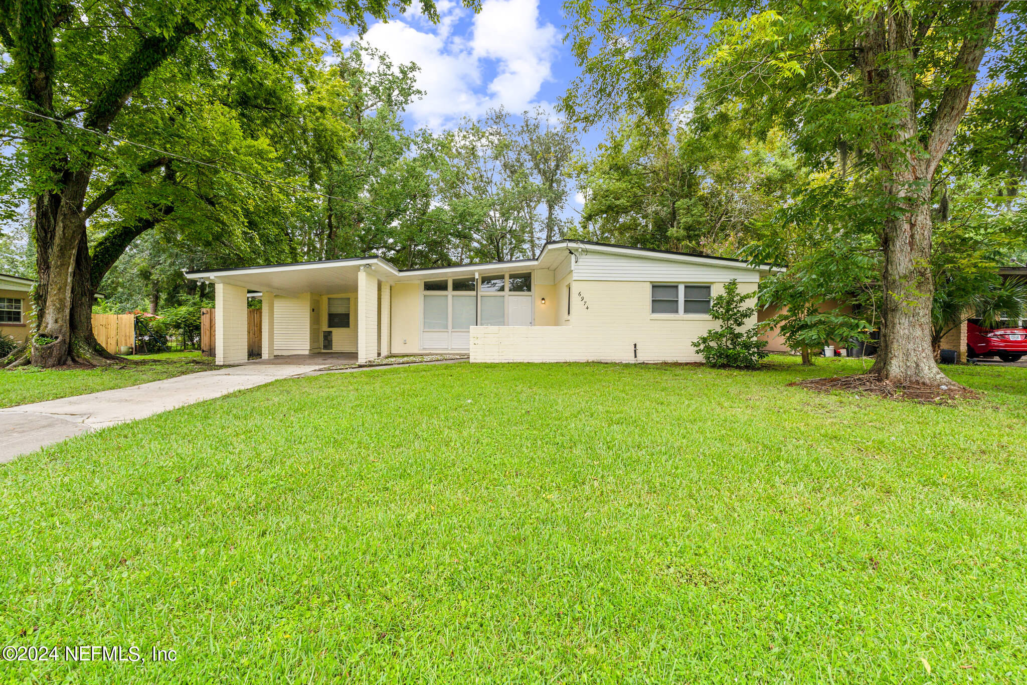 6974 Rollo Road Jacksonville, FL 32205 - Photo 1 of 16 a front view of house with yard and green space