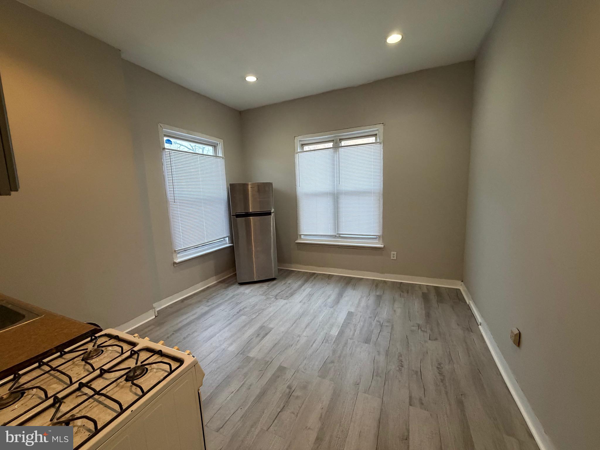 4643 Leiper Street, Unit 1 Philadelphia, PA 19124 - Photo 3 of 9 an empty room with wooden floor closet and windows