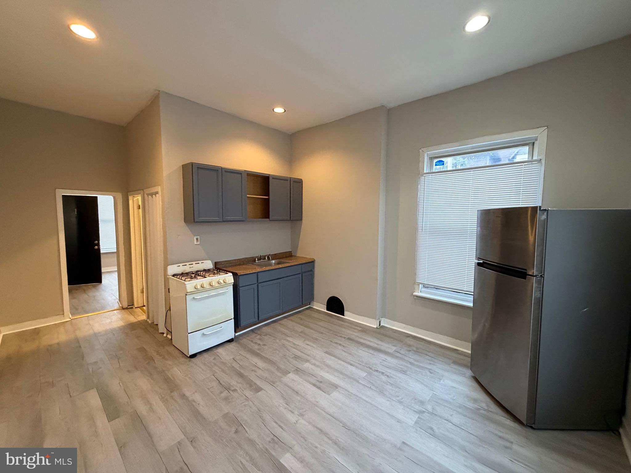 4643 Leiper Street, Unit 1 Philadelphia, PA 19124 - Photo 4 of 9 a kitchen with stainless steel appliances a refrigerator and a stove top oven