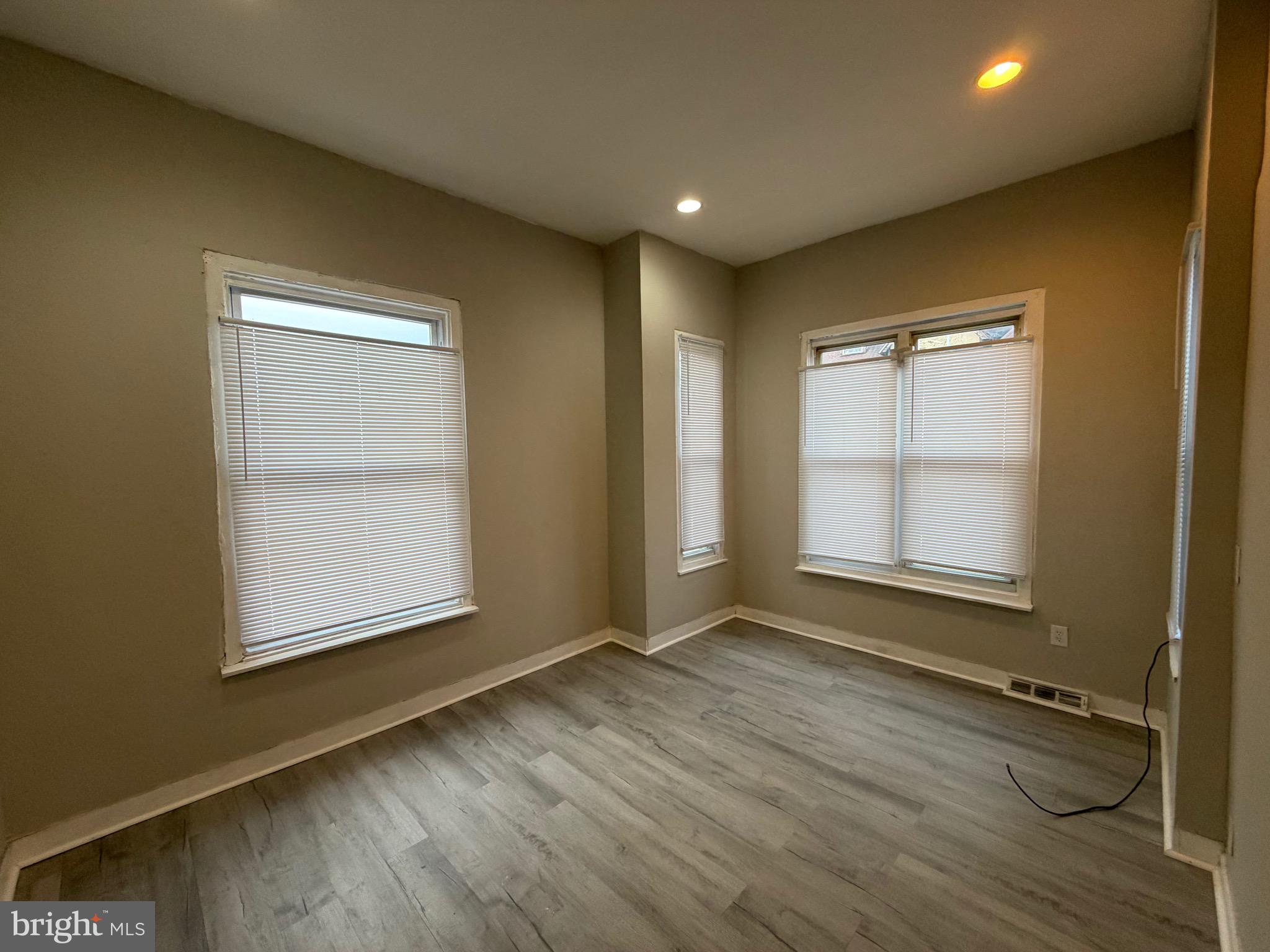 4643 Leiper Street, Unit 1 Philadelphia, PA 19124 - Photo 6 of 9 an empty room with wooden floor and windows