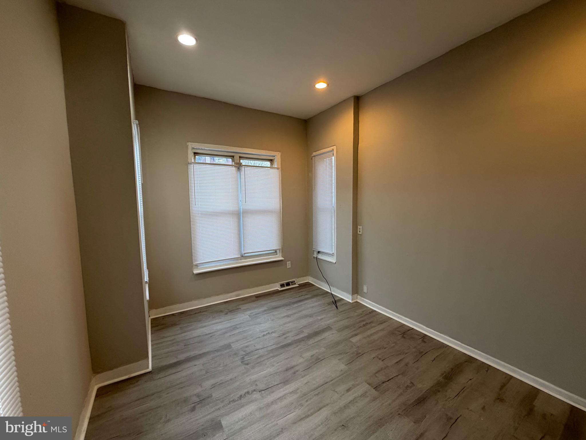 4643 Leiper Street, Unit 1 Philadelphia, PA 19124 - Photo 7 of 9 an empty room with wooden floor and windows