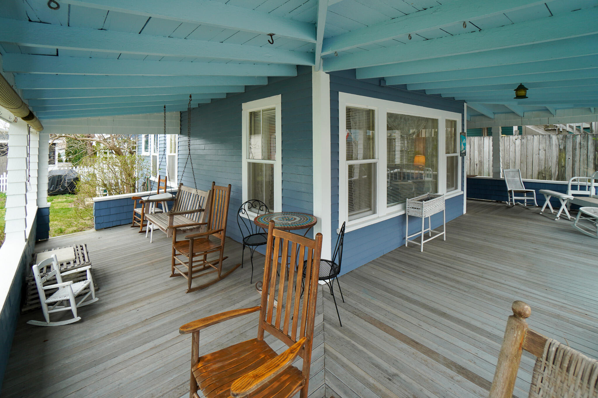 5 Tabernacle Avenue Oak Bluffs, MA 02557 - Photo 33 of 37 a view of a patio with table and chairs with wooden floor and floor to ceiling window