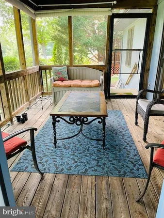 a view of a living room and floor to ceiling window or wooden floor
