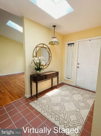 a view of a bedroom with wooden floor and a potted plant