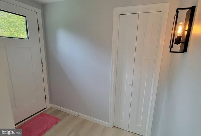 a view of an entryway with wooden floor