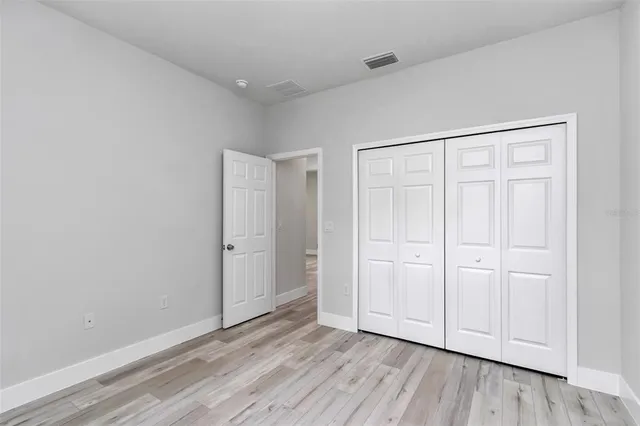 a view of an empty room and wooden floor