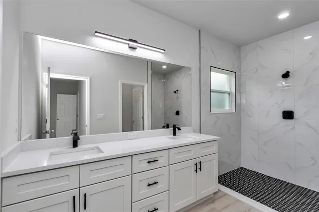 a bathroom with a double vanity sink and mirror