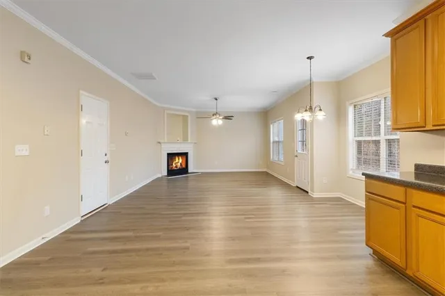 a view of a kitchen with wooden floor and a sink