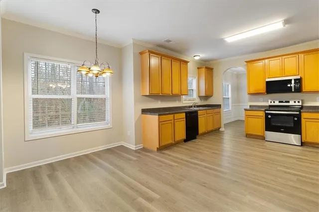 a kitchen with stainless steel appliances granite countertop a stove and a sink