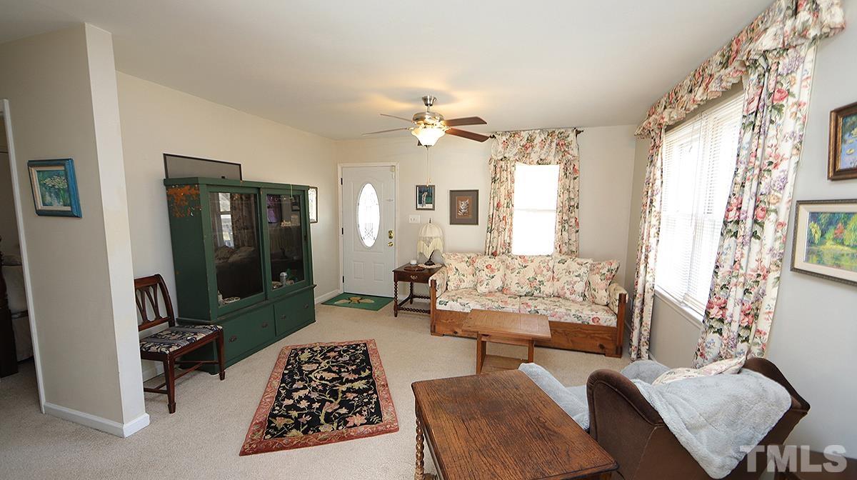 10633 Old Stage Road Raleigh, NC 27603 - Photo 3 of 20 a bedroom with furniture and a large window