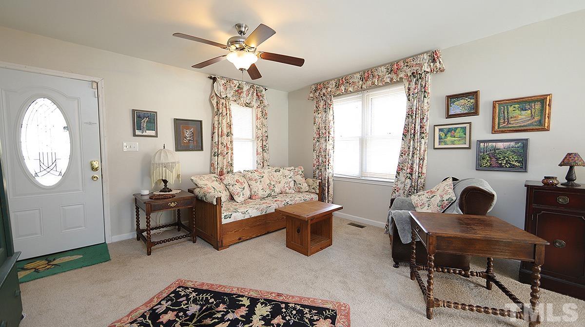 10633 Old Stage Road Raleigh, NC 27603 - Photo 4 of 20 a living room with furniture and a large window