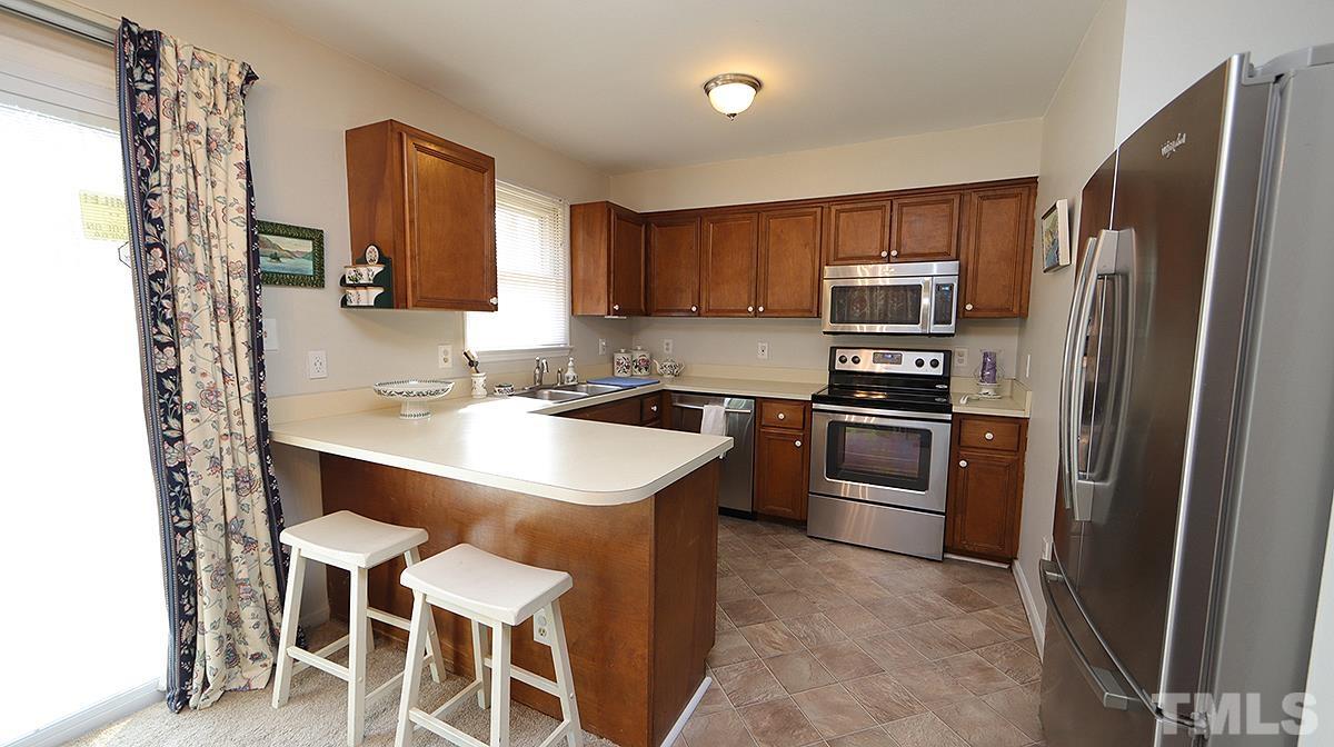 10633 Old Stage Road Raleigh, NC 27603 - Photo 7 of 20 a kitchen with a sink appliances and cabinets