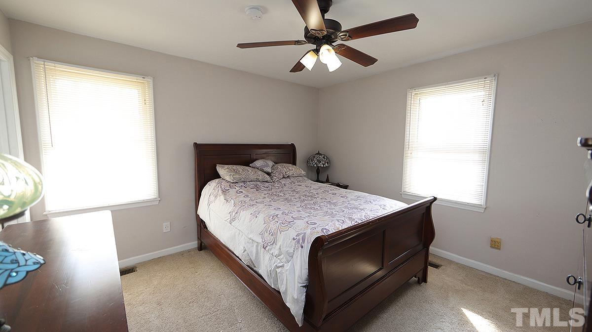 10633 Old Stage Road Raleigh, NC 27603 - Photo 9 of 20 a bedroom with a bed and a window