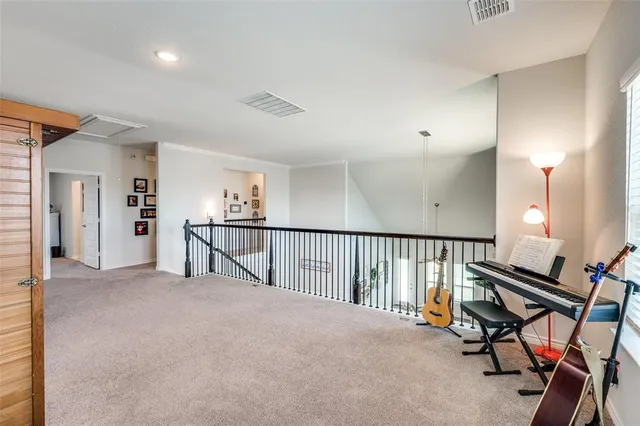 a spacious bedroom with a bed a dresser and a book shelf