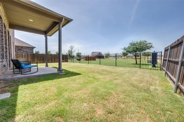 a large bed sitting in a bedroom next to a window