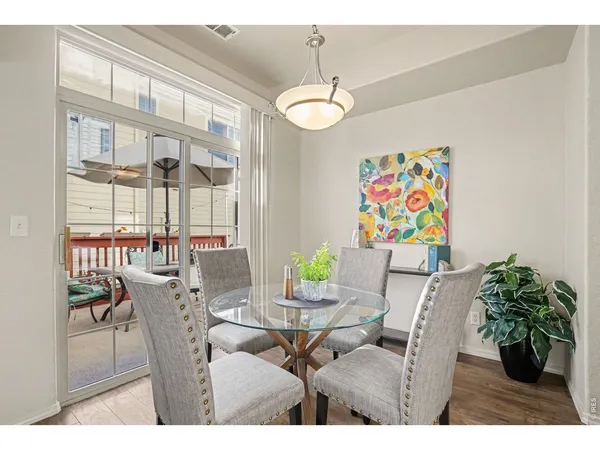 a view of a dining room with furniture and chandelier