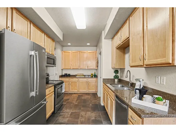 a kitchen with a sink stove and refrigerator