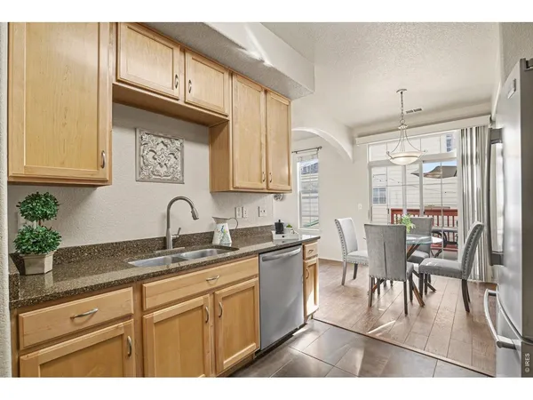 a kitchen with stainless steel appliances granite countertop a sink and cabinets