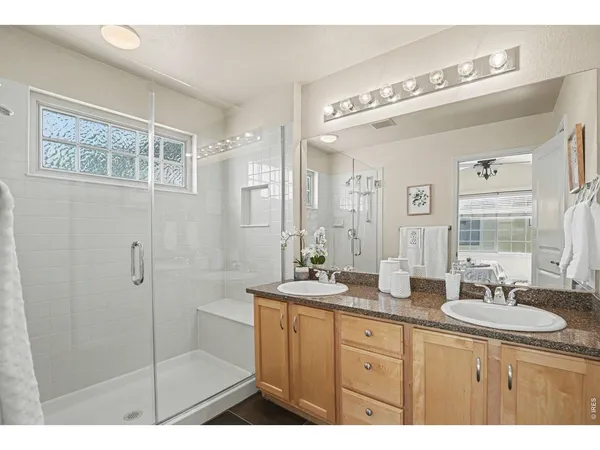 a bathroom with a granite countertop sink mirror and double