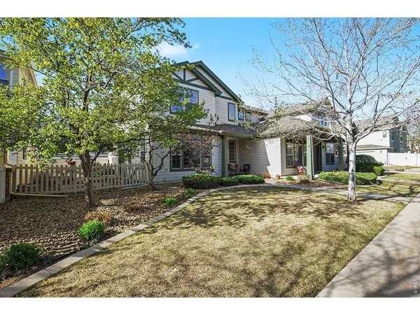 a view of a yard with a house and a tree