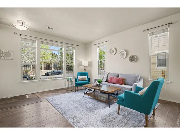 a living room with furniture and a large window