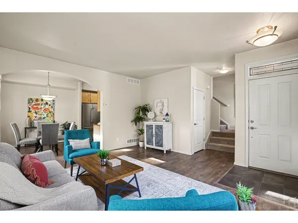 a living room with furniture and wooden floor