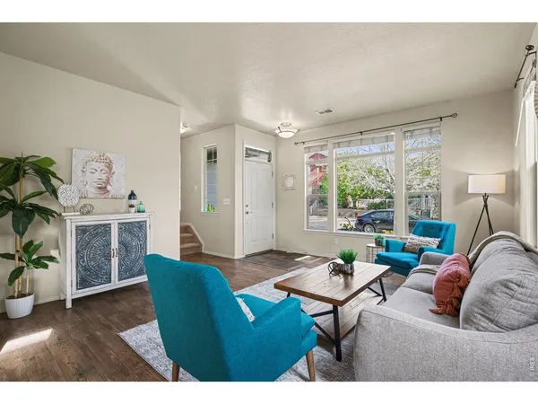 a living room with furniture a fireplace and a table