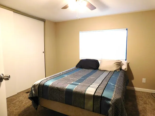 a bedroom with a bed and a window