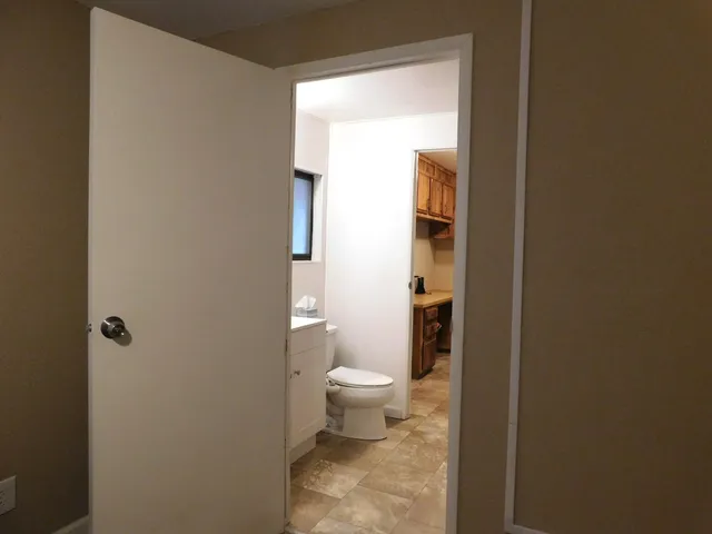 a bathroom with a toilet and a shower