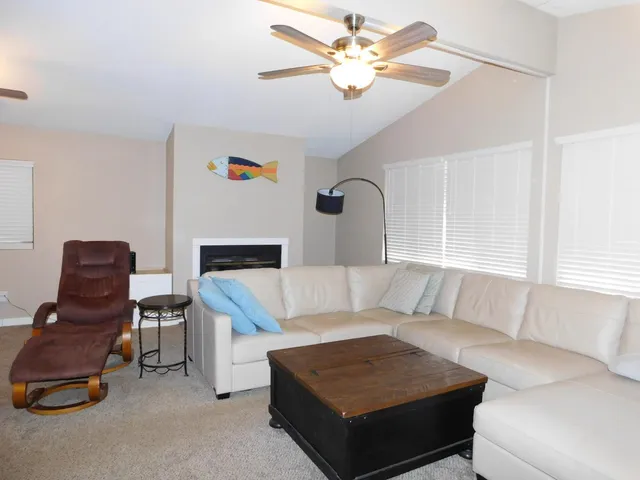 a living room with furniture and a chandelier