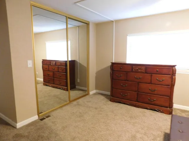 a room with a dresser and a mirror