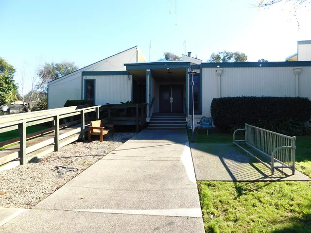 a kitchen with stainless steel appliances a sink a stove a refrigerator and cabinets