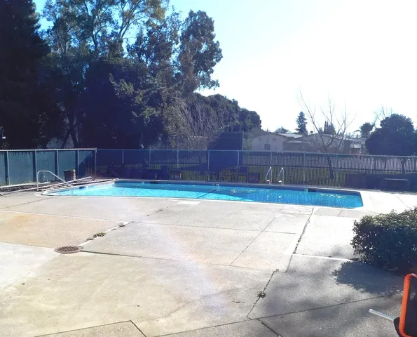 a view of a roof deck with two chairs and a table