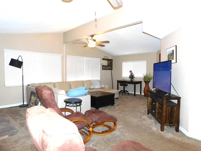 a living room with furniture a wooden floor and a chandelier