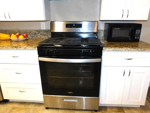 a stove top oven sitting inside of a kitchen
