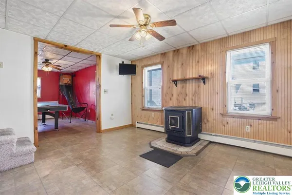 a kitchen with granite countertop a sink cabinets stainless steel appliances and a window