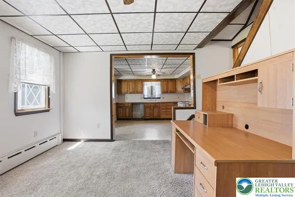 a room with pool table and window