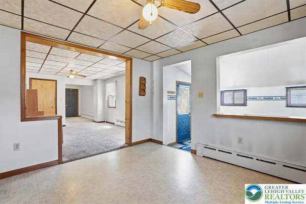 a bathroom with a toilet and a shower curtain