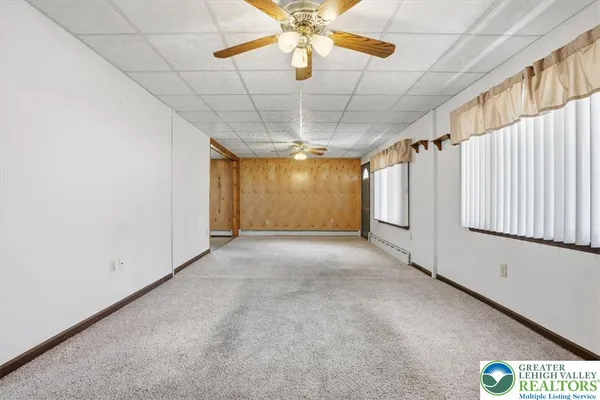 a view of a livingroom with a ceiling fan and window