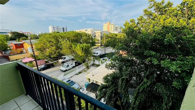 a balcony view with two chairs and a table