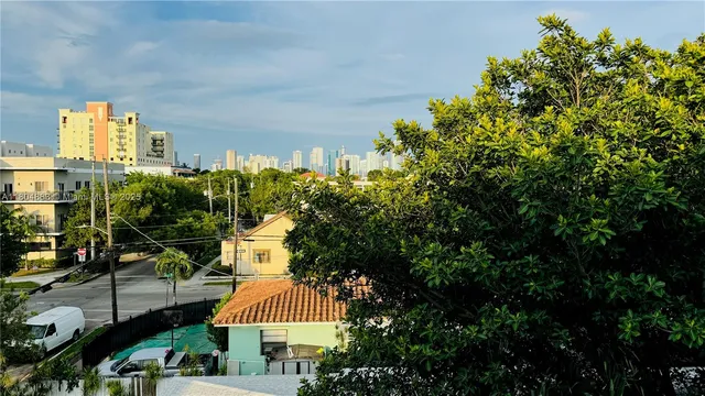a front view of a house with a yard and fountain