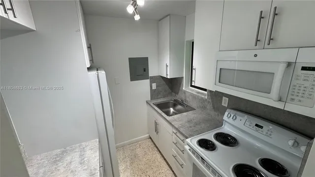 a kitchen with appliances and cabinets
